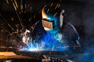 A picture of a welder live welding an object.